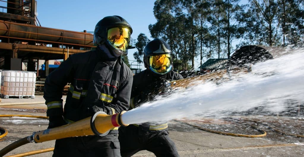 Firefighters spraying Solberg Versagard 1x3